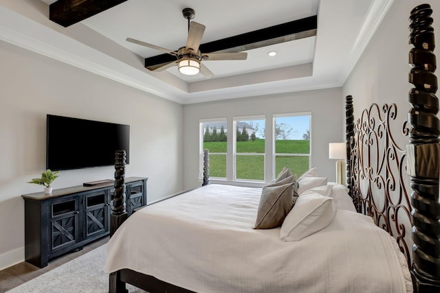 bedroom featuring dark wood-type flooring, ceiling fan, crown molding, and a raised ceiling