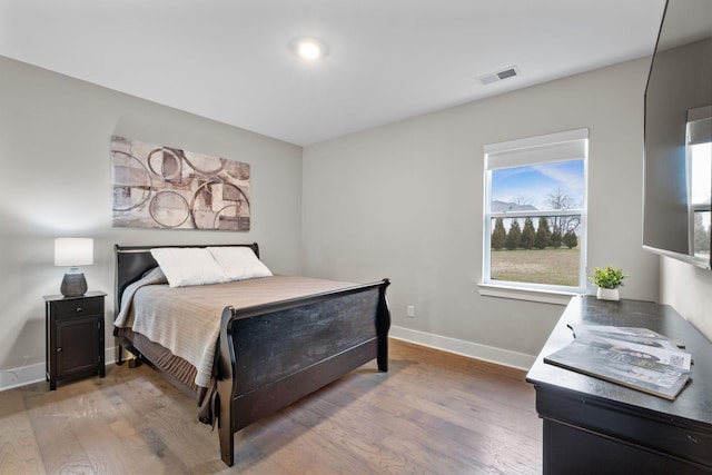 bedroom with hardwood / wood-style flooring