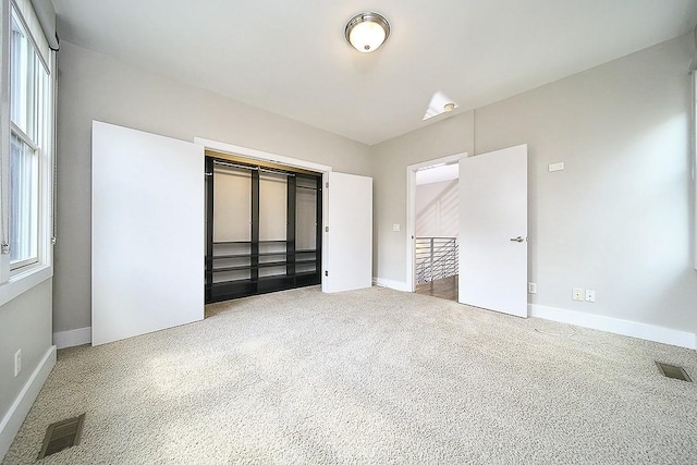 unfurnished bedroom featuring carpet and a closet