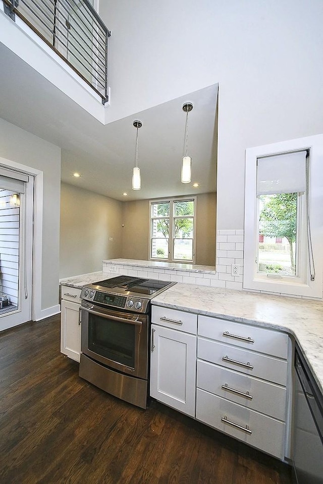 kitchen featuring white cabinetry, black dishwasher, hanging light fixtures, light stone countertops, and electric stove