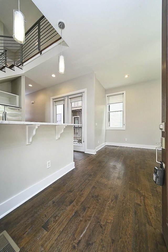 unfurnished living room with dark hardwood / wood-style floors