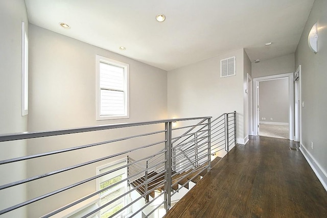 hallway with hardwood / wood-style flooring