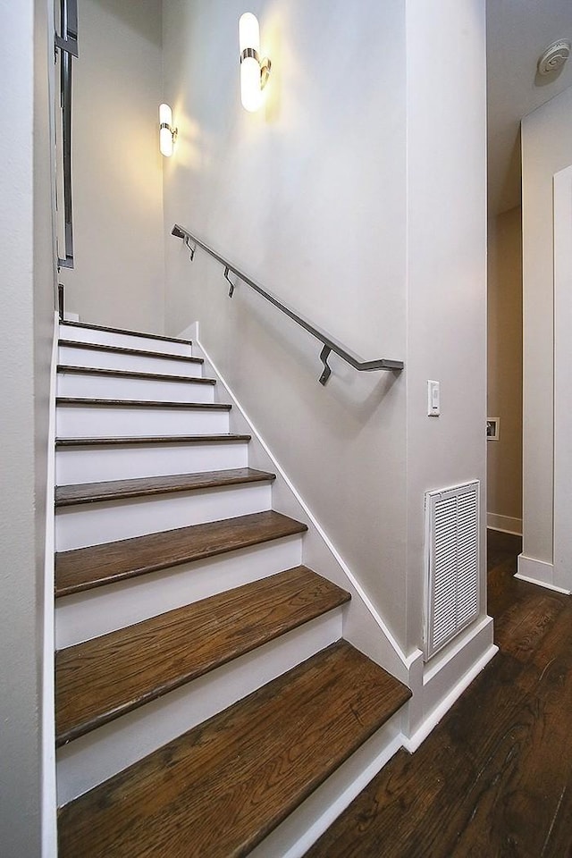 stairway with hardwood / wood-style flooring