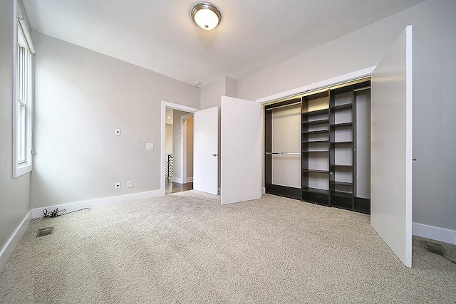 unfurnished bedroom with carpet flooring and a closet