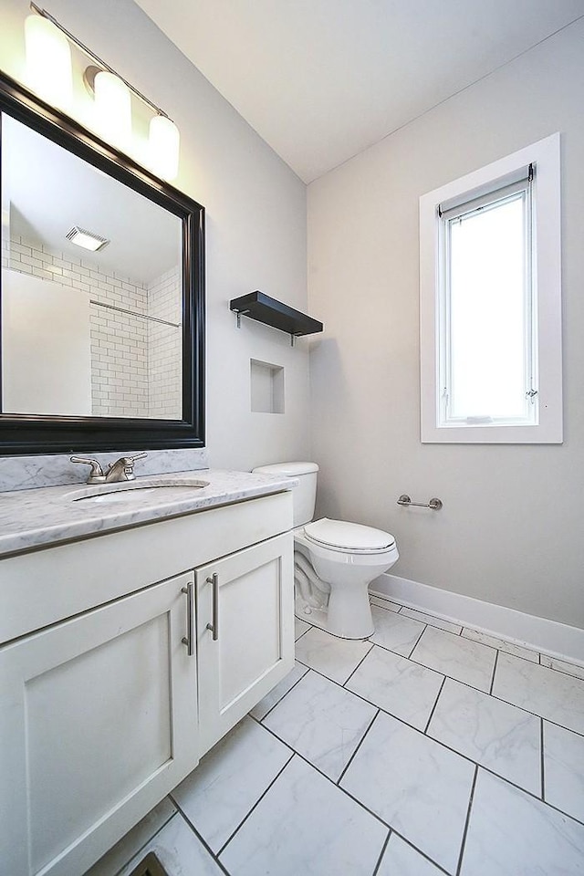 bathroom featuring vanity and toilet