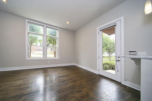 interior space with a healthy amount of sunlight and dark hardwood / wood-style floors