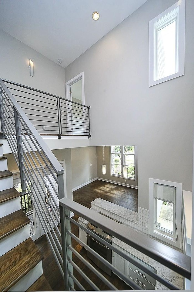 staircase with hardwood / wood-style flooring