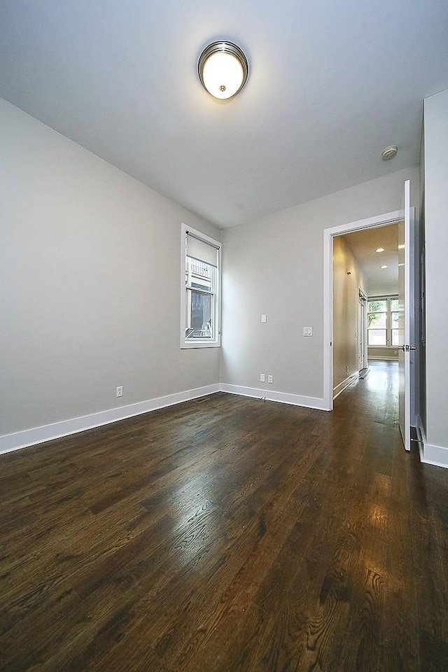 unfurnished room featuring dark wood-type flooring