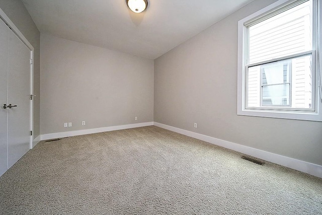 additional living space with plenty of natural light and carpet