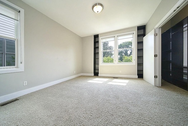 unfurnished bedroom featuring light carpet