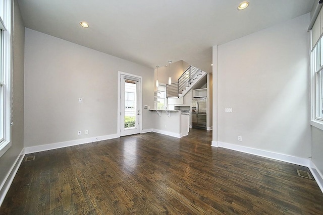 unfurnished living room featuring dark wood-type flooring