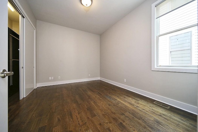 unfurnished bedroom featuring dark hardwood / wood-style flooring