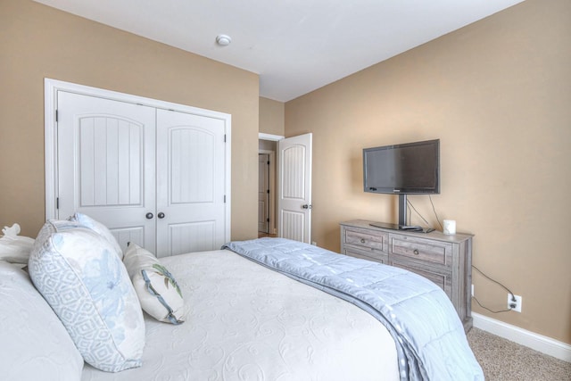 carpeted bedroom with a closet