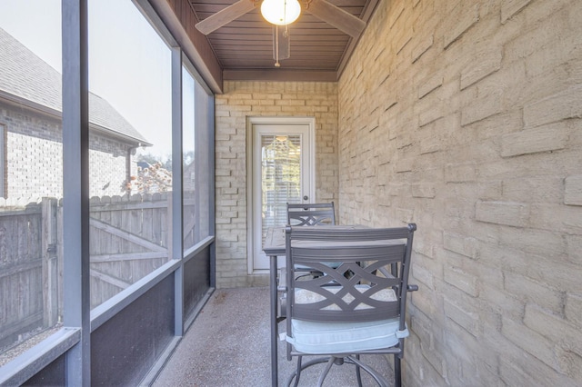 sunroom / solarium featuring wooden ceiling and ceiling fan