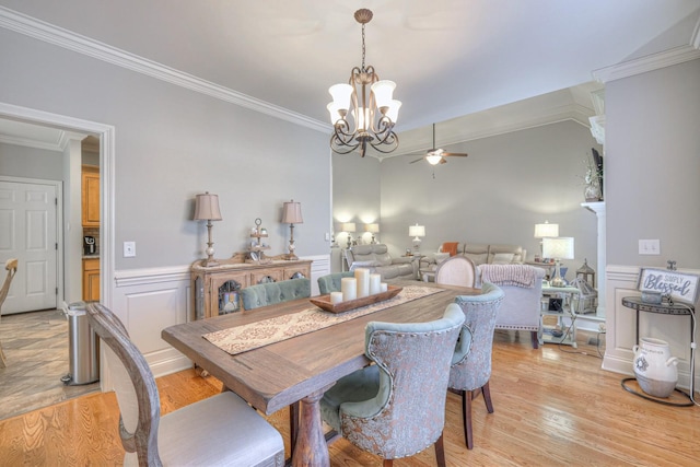 dining area featuring ceiling fan with notable chandelier, light hardwood / wood-style flooring, and ornamental molding