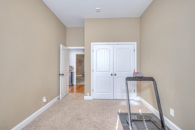 exercise room featuring light carpet