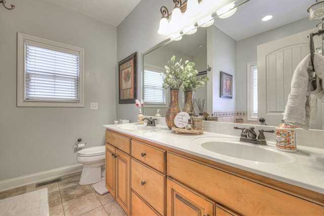 bathroom with vanity, toilet, a chandelier, and tile patterned flooring