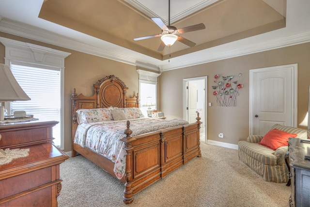 bedroom with crown molding, light colored carpet, a raised ceiling, and ceiling fan