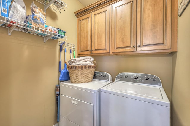 washroom featuring cabinets and independent washer and dryer