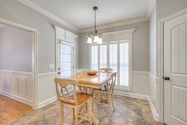 dining room with crown molding, a chandelier, and a healthy amount of sunlight