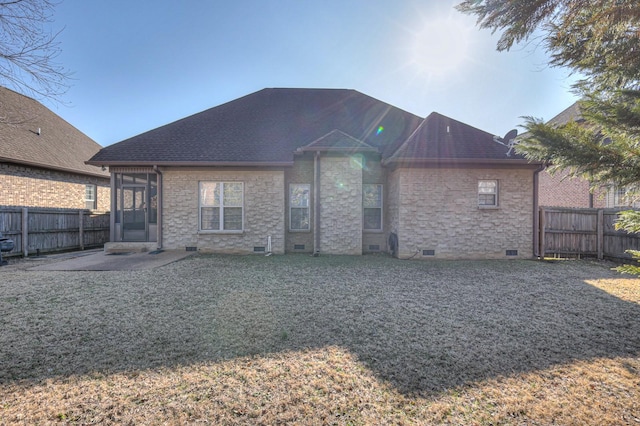 back of property with a yard and a patio