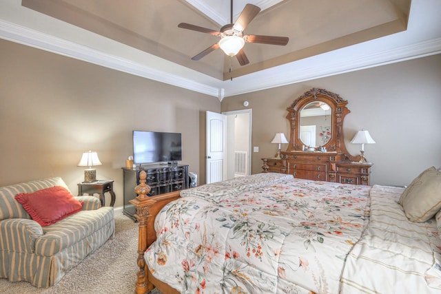 bedroom with crown molding, ceiling fan, a tray ceiling, and carpet floors