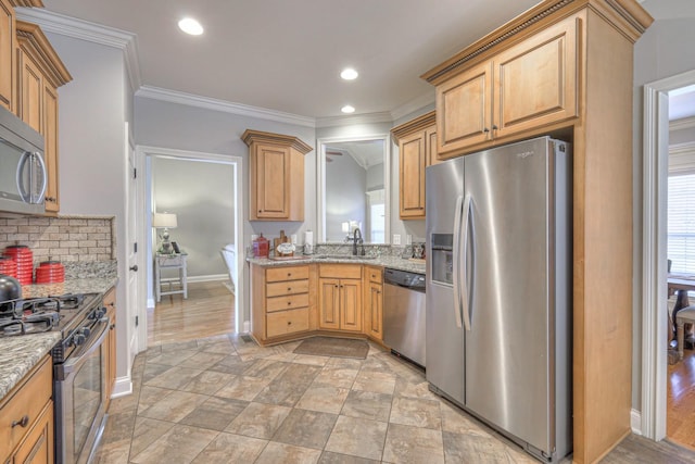 kitchen with sink, backsplash, ornamental molding, stainless steel appliances, and light stone countertops