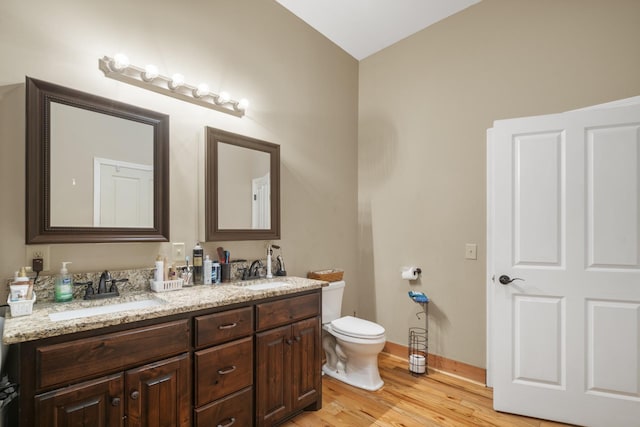 bathroom featuring vanity, hardwood / wood-style floors, and toilet