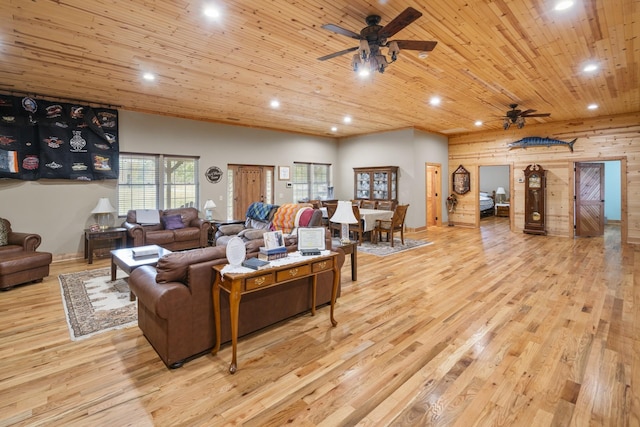 living room featuring ceiling fan, wooden walls, light hardwood / wood-style flooring, and wooden ceiling