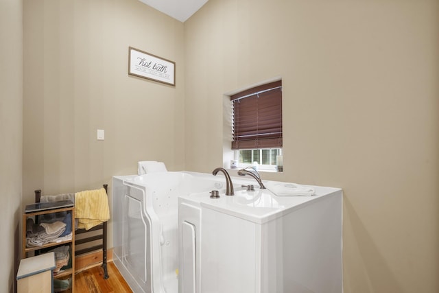 laundry room with light hardwood / wood-style floors