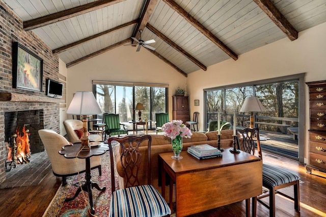 living room with high vaulted ceiling, hardwood / wood-style floors, a fireplace, and beam ceiling