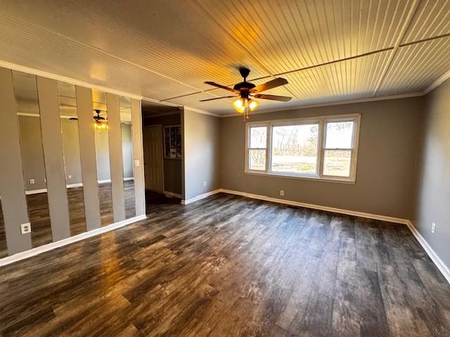 spare room with dark wood-type flooring, ceiling fan, and crown molding