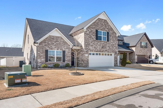 view of front of home with a garage and central AC unit