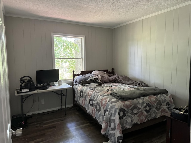 bedroom featuring dark hardwood / wood-style floors, a textured ceiling, and wood walls