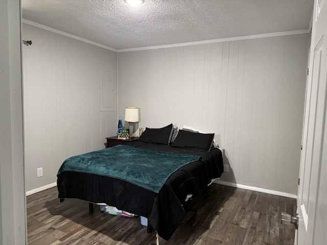 bedroom with crown molding, dark hardwood / wood-style floors, and a textured ceiling