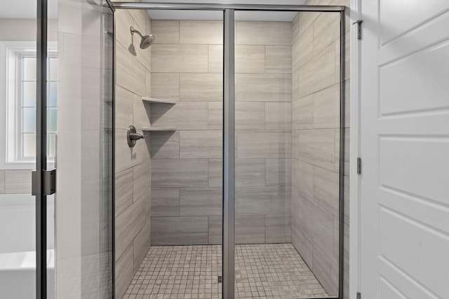 bathroom with a shower with door