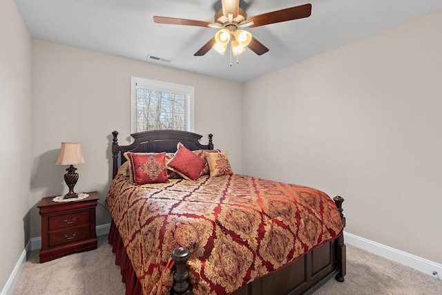 bedroom with ceiling fan and light carpet