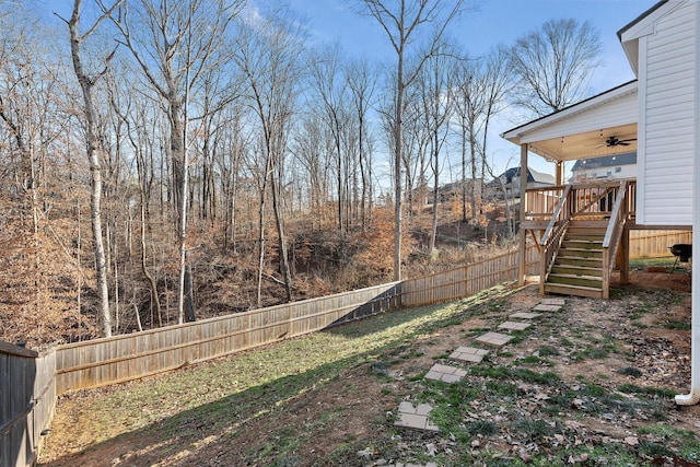 view of yard featuring ceiling fan and a deck