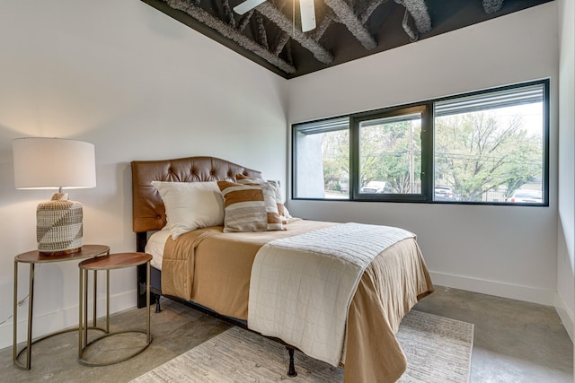 bedroom featuring multiple windows, ceiling fan, and concrete floors