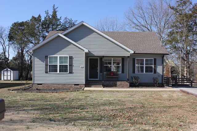 view of front of home with a front lawn and a storage unit