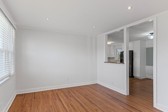 spare room with wood-type flooring