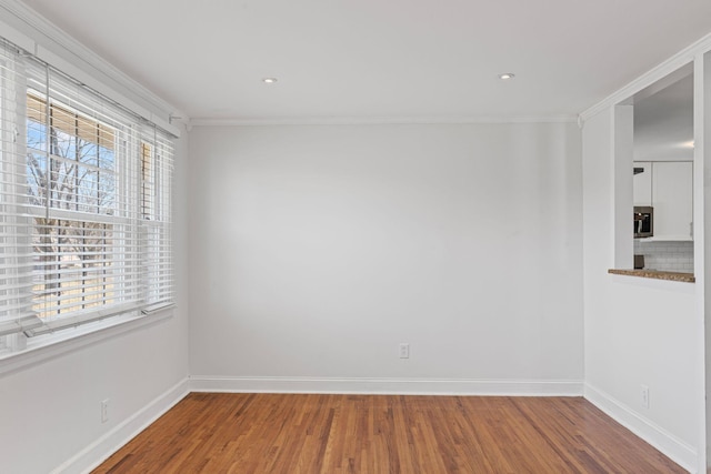 spare room with wood-type flooring and ornamental molding