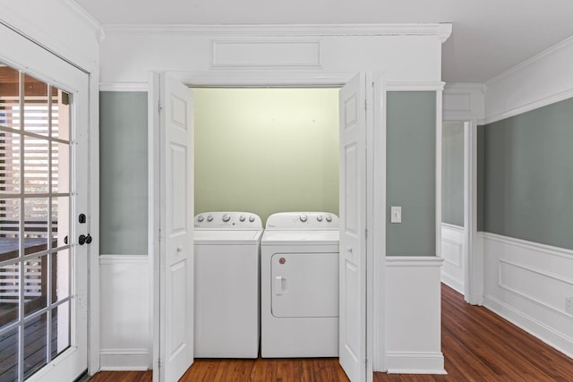 washroom with crown molding, washer and dryer, and dark hardwood / wood-style flooring