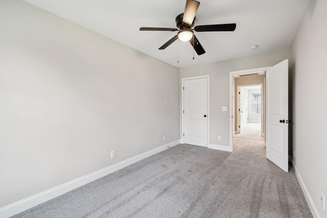 unfurnished bedroom with ceiling fan and carpet