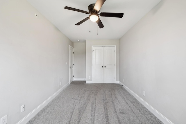 unfurnished bedroom featuring carpet floors, ceiling fan, and a closet