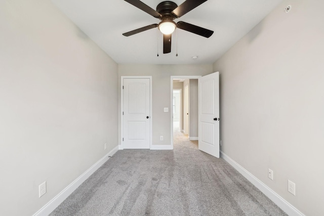 unfurnished bedroom featuring light colored carpet and ceiling fan