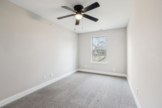 carpeted spare room featuring ceiling fan