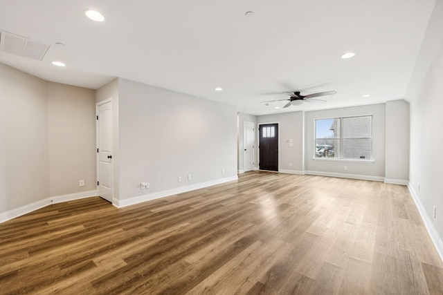 unfurnished living room featuring wood-type flooring and ceiling fan