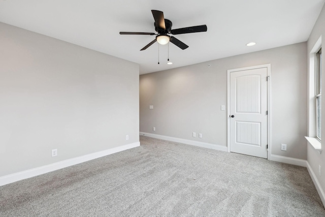 empty room with ceiling fan and carpet floors