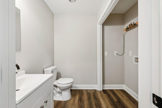 bathroom featuring vanity, toilet, and wood-type flooring